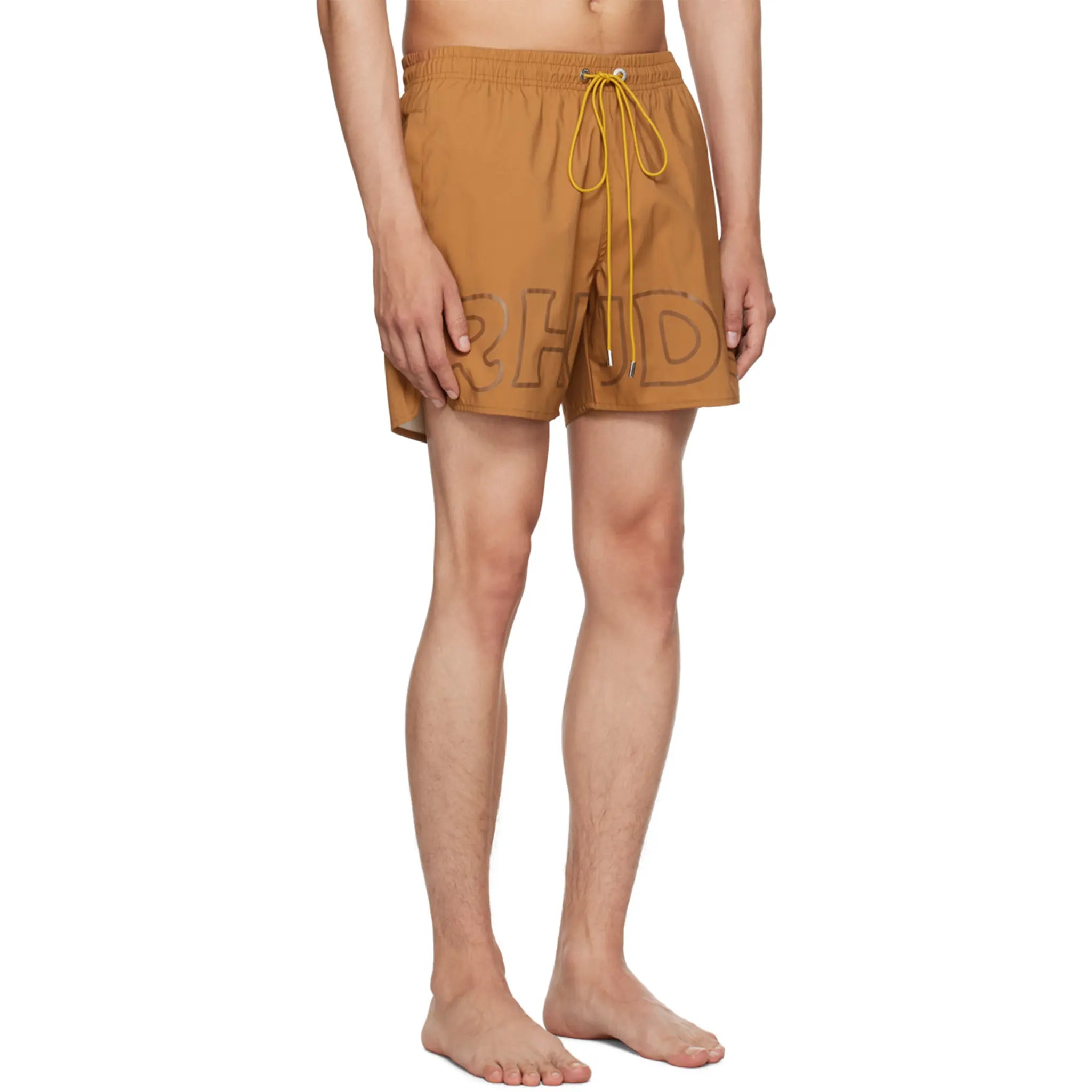 Model side view of Rhude Logo Swim Shorts Camel RHPF23SM01169003