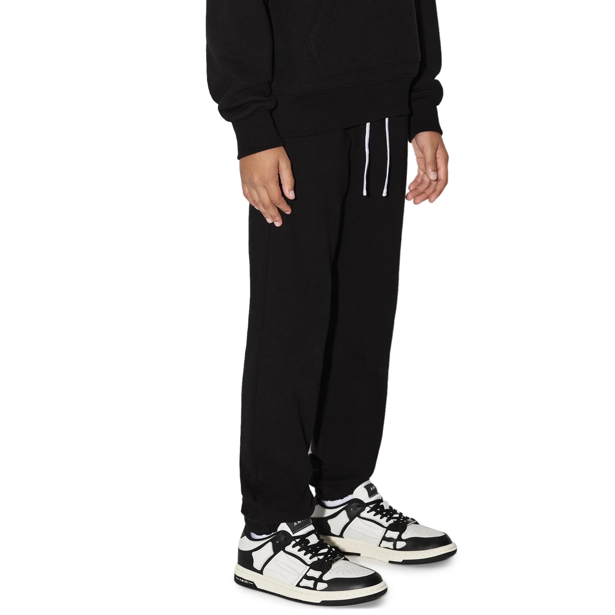 Model side view of Amiri Kids 'Amiri' Black Sweatpants PS23KJL003-001