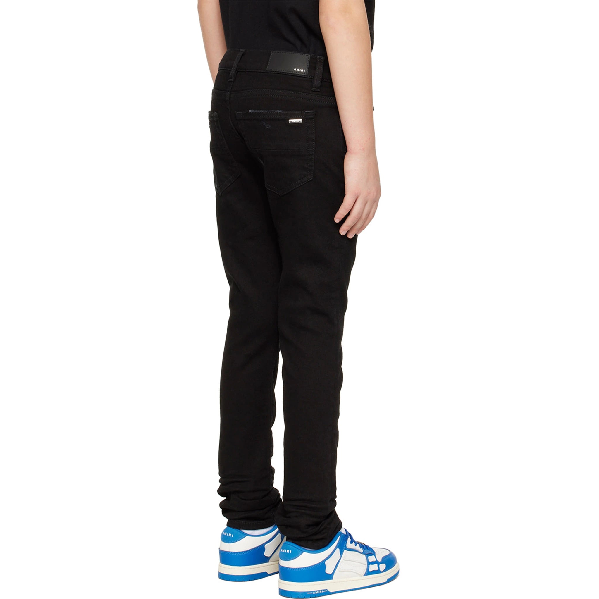 Model back view of Amiri Kids Stack Black Jeans PF22KDS004-018