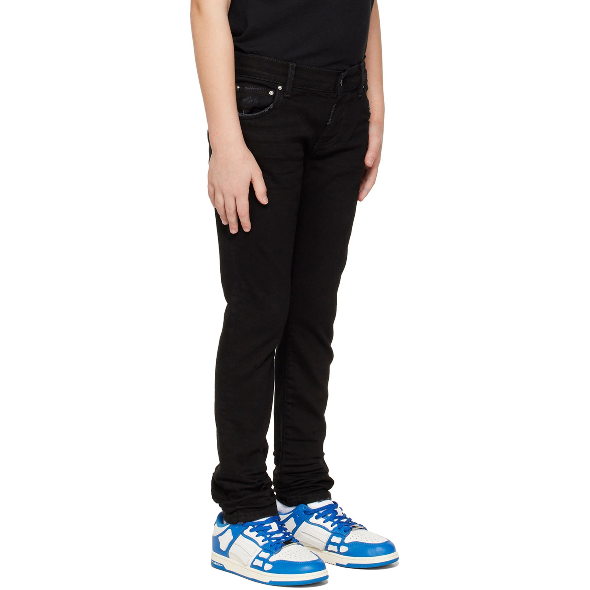 Model side view of Amiri Kids Stack Black Jeans PF22KDS004-018