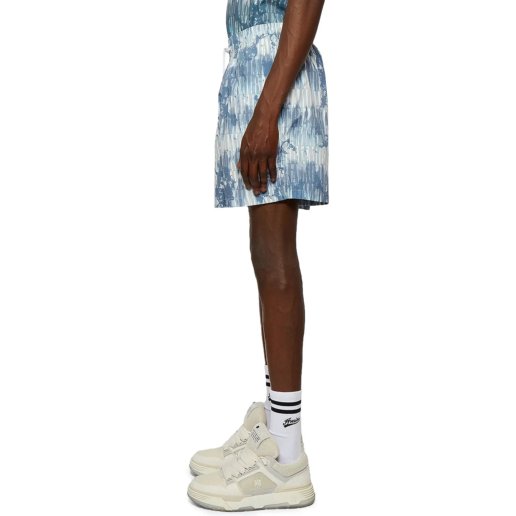 Model side view of Amiri Tie Dye Blue Swim Shorts SS23MSB002-420