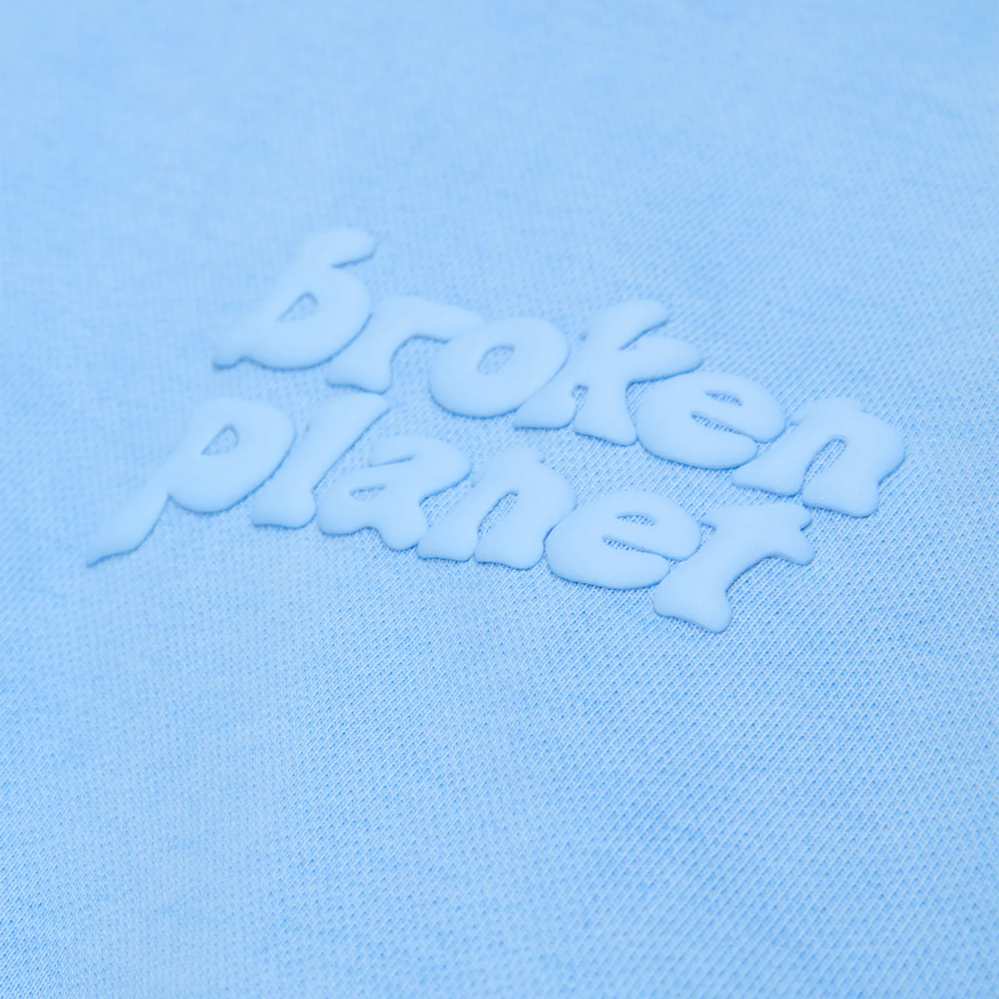 Logo view of Broken Planet Basics Washed Light Blue Hoodie