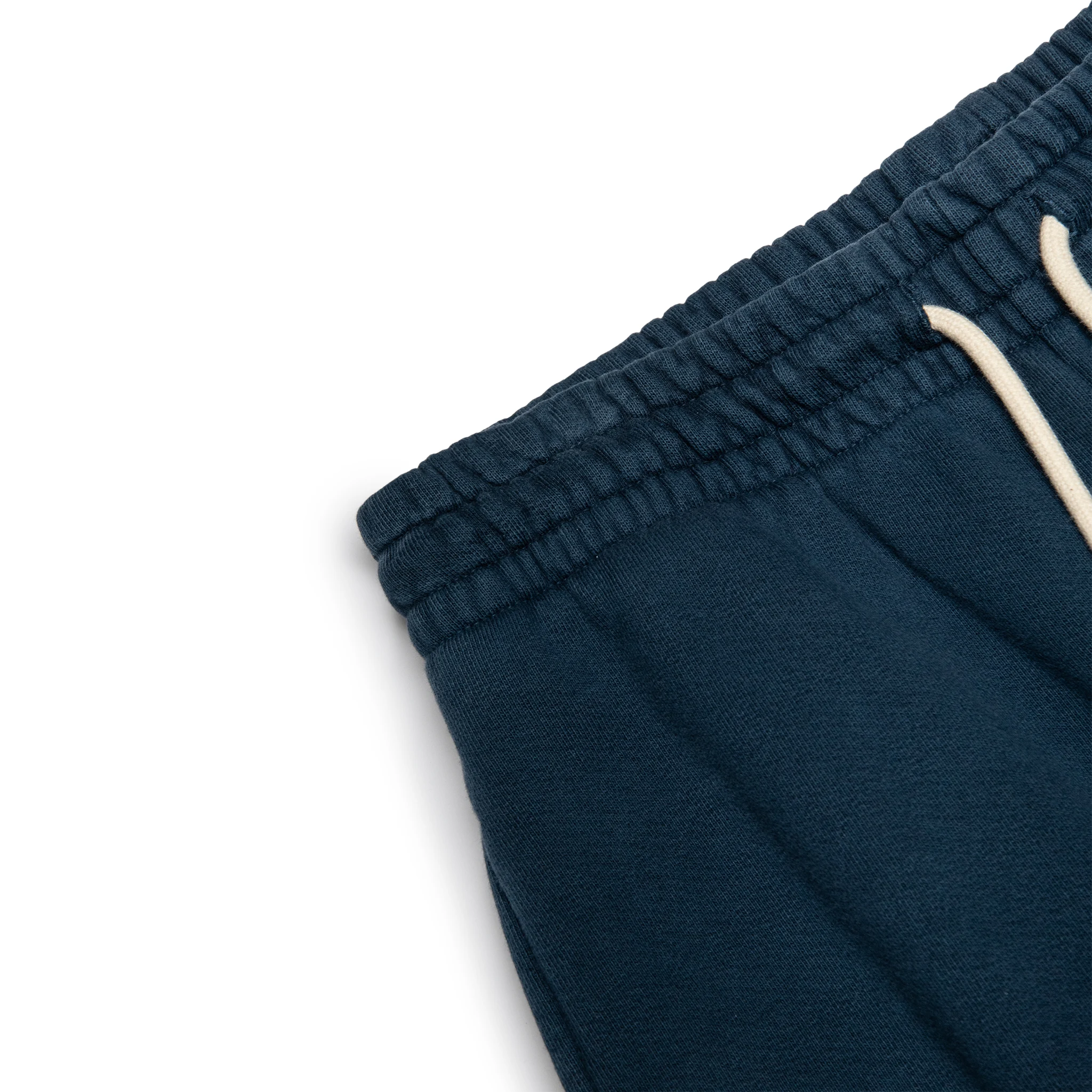 Corner view of Denim Tears University Navy Sweatpants 