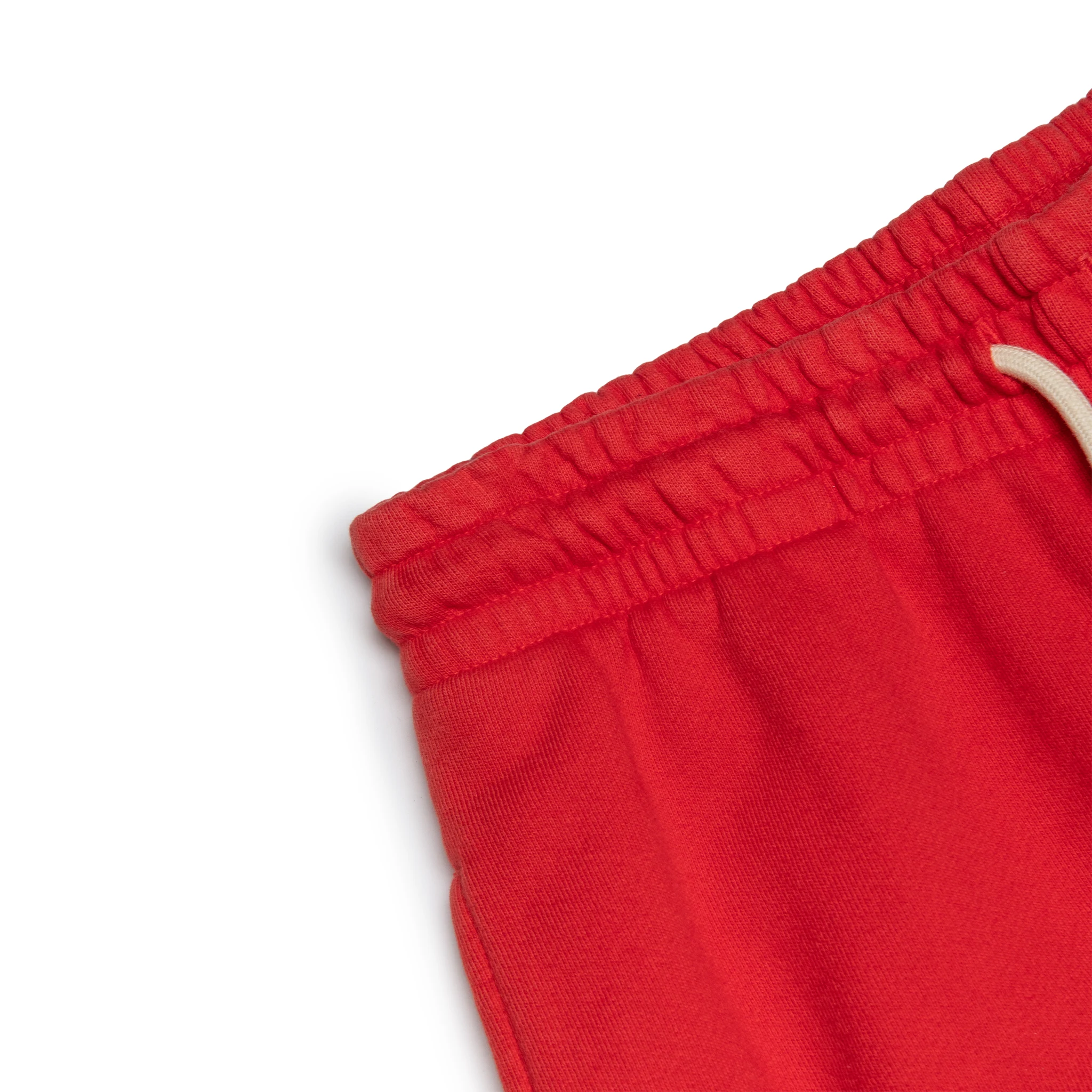 Corner view of Denim Tears University Red Sweatpants 