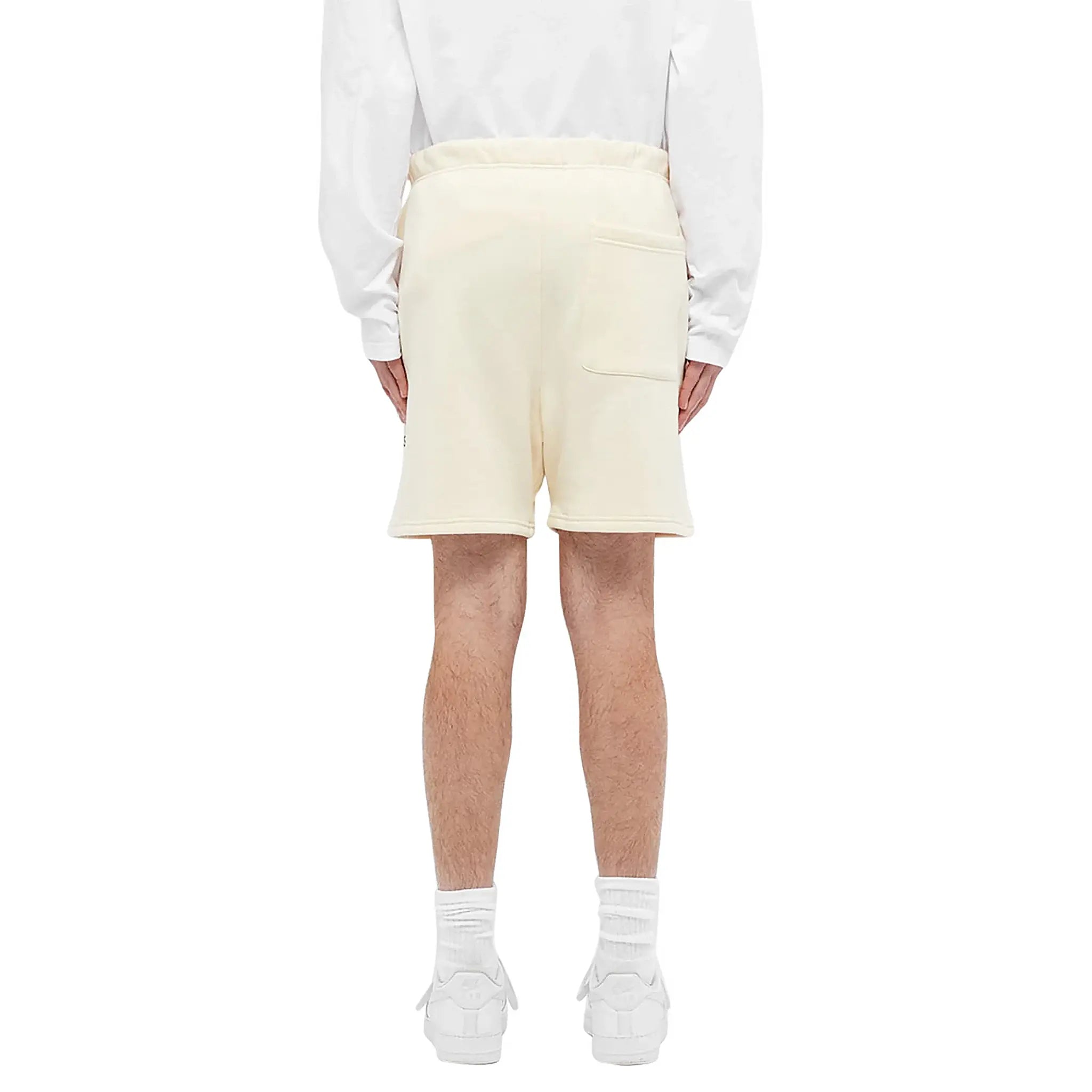 Model back view of Fear Of God Essentials Buttercream Reflective Shorts 160SP202011F