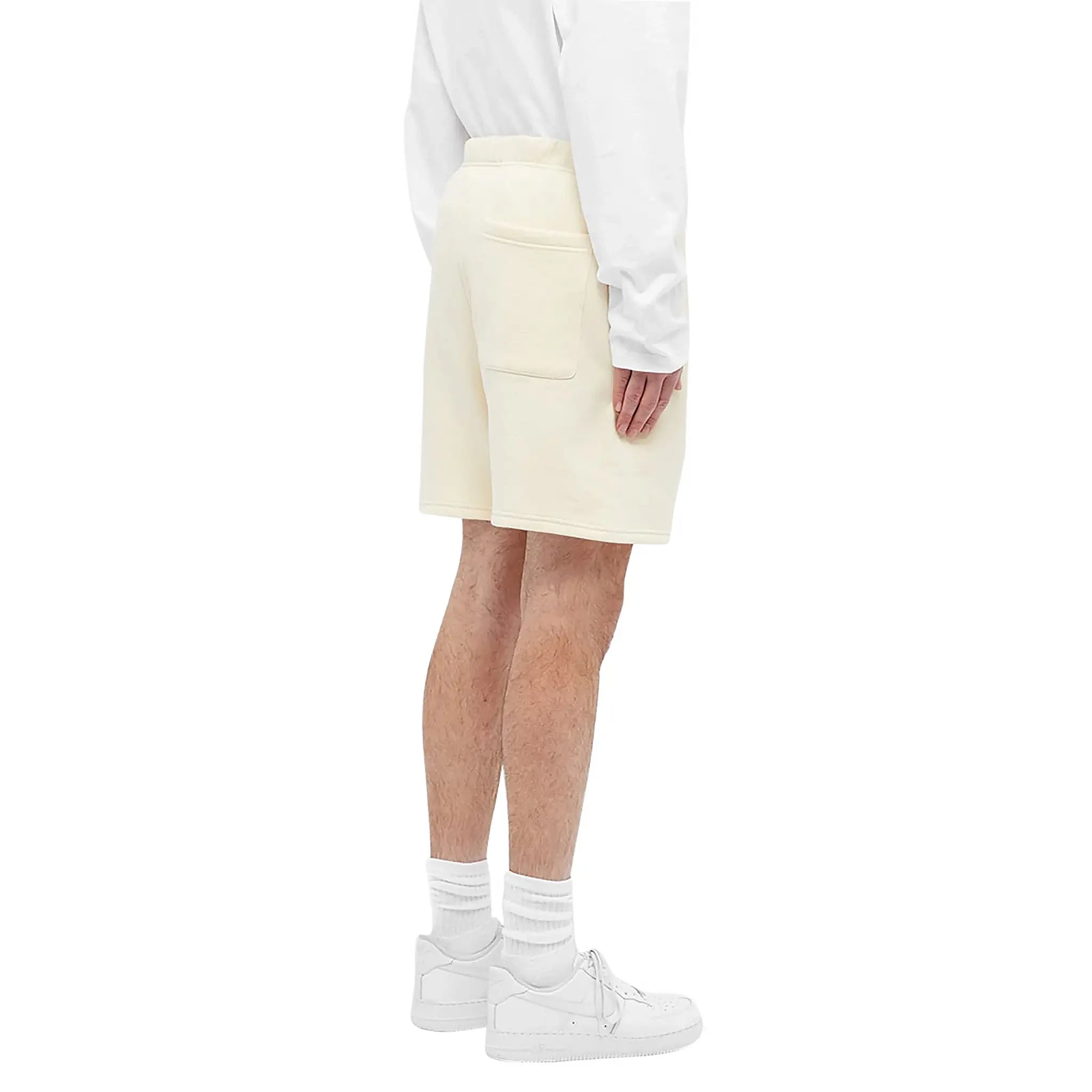 Model Side view of Fear Of God Essentials Buttercream Reflective Shorts 160SP202011F