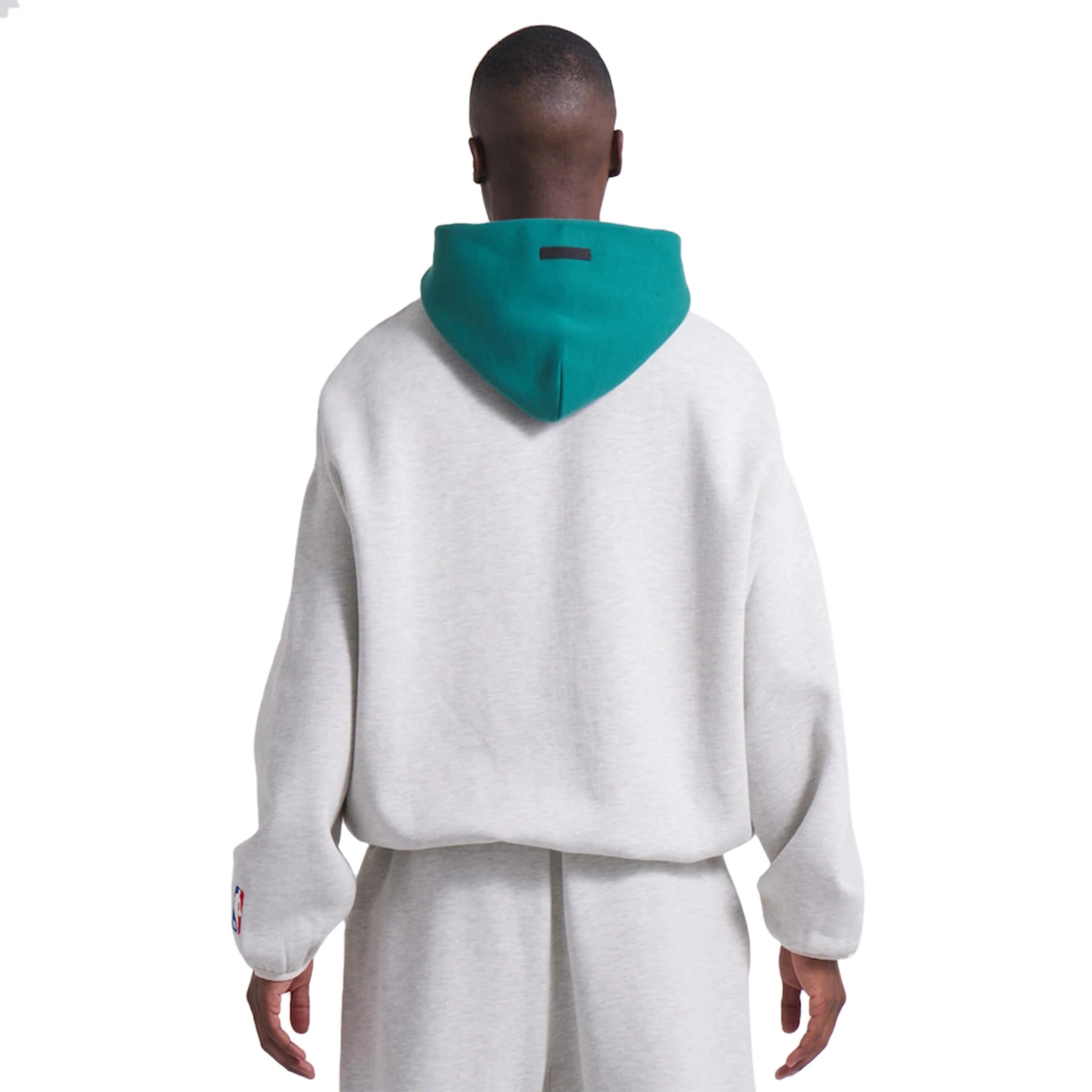 Model back view of Fear Of God Essentials x Celtics Light Heather Hoodie