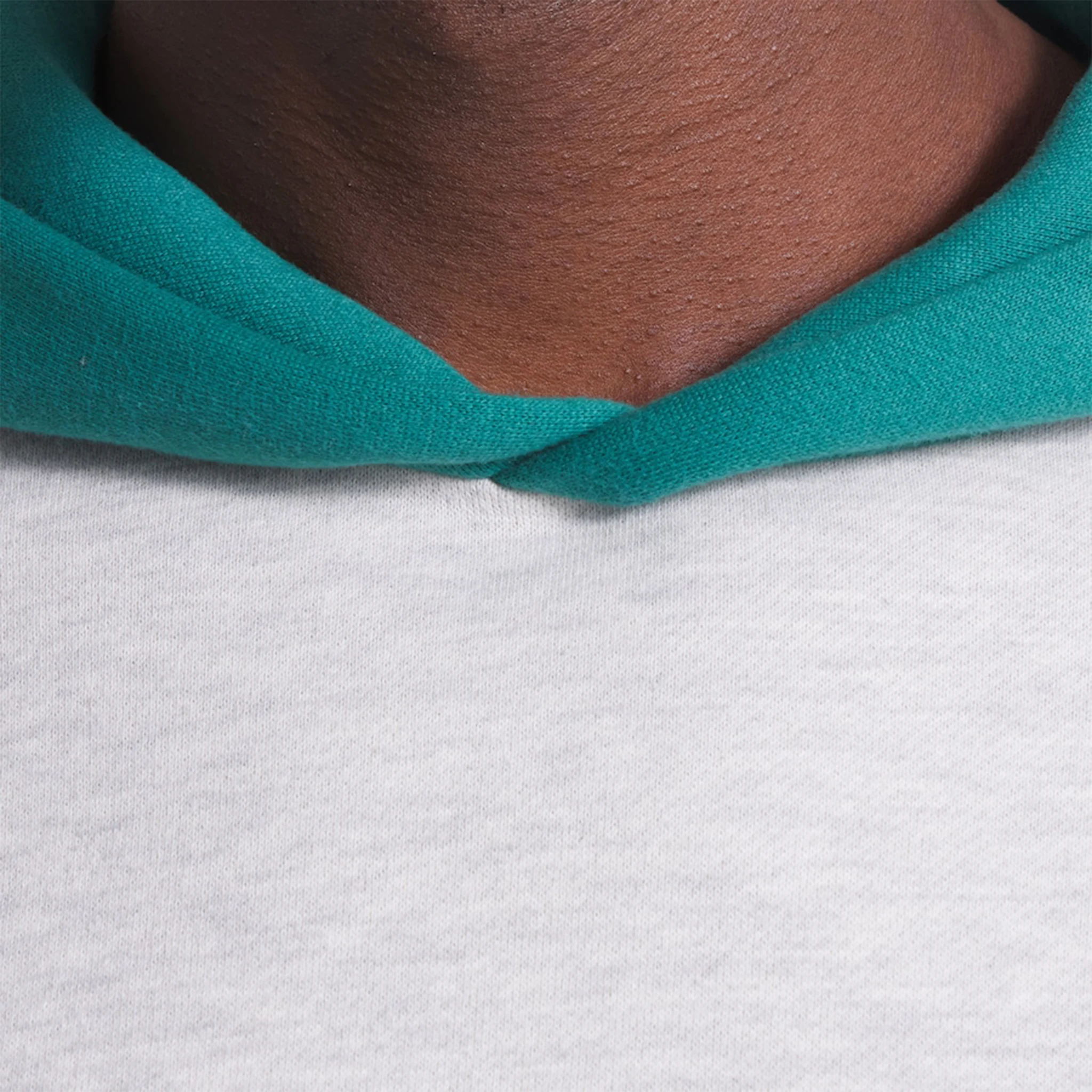 Model neck view of Fear Of God Essentials x Celtics Light Heather Hoodie