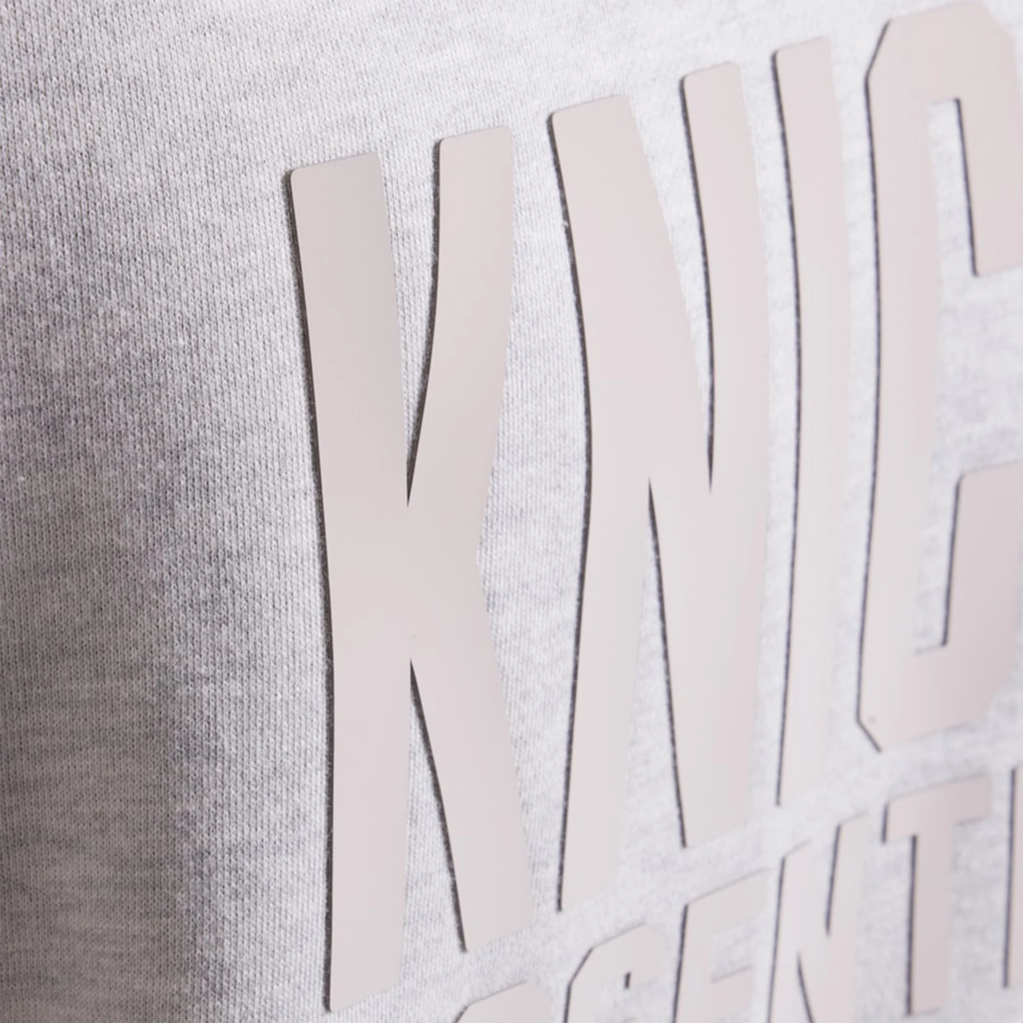 Front detail view of Fear Of God Essentials x Knicks Light Heather Hoodie