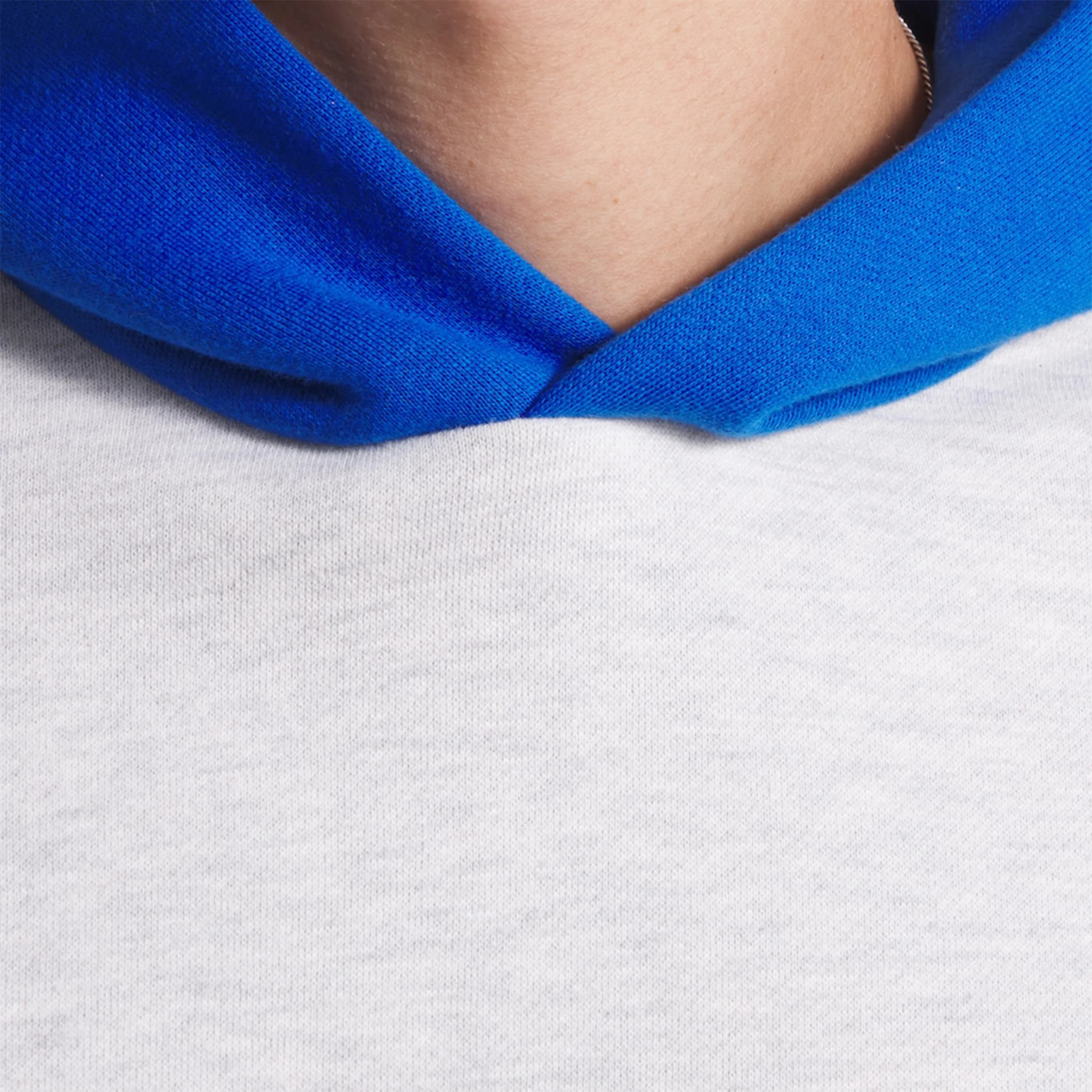 Model neck view of Fear Of God Essentials x Knicks Light Heather Hoodie