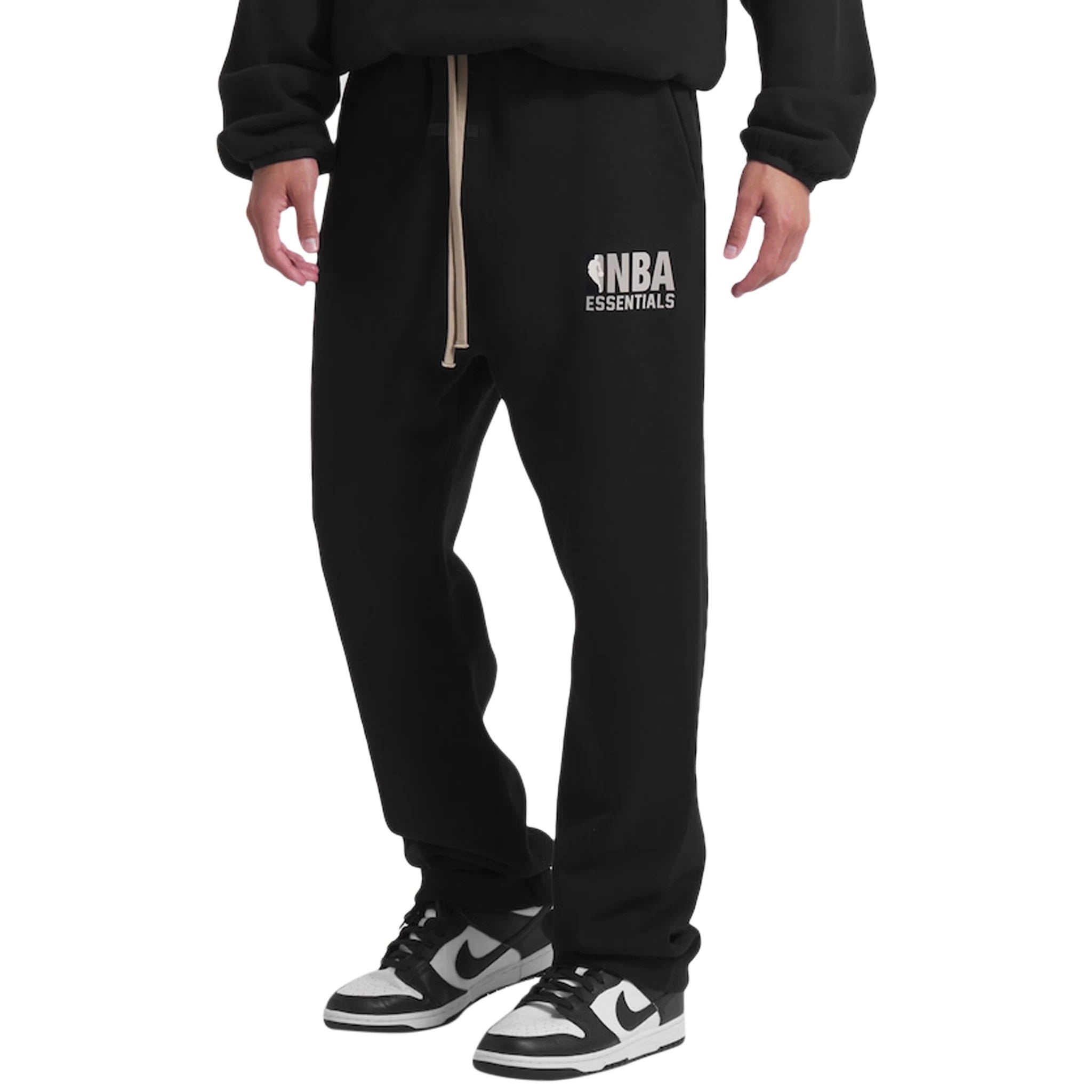 Model front view of Fear of God Essentials x NBA Relaxed Black Sweatpants 130AL246001F