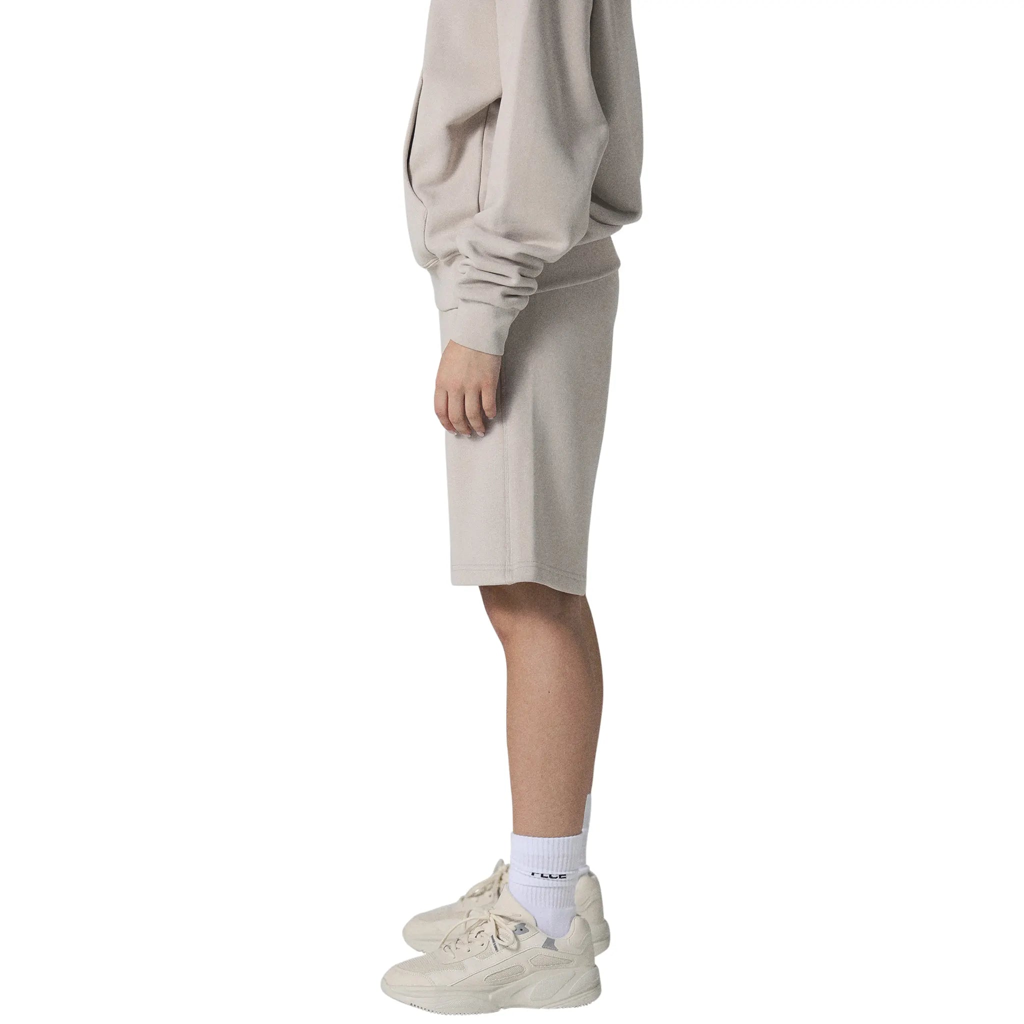 Model female side view of Human Race Stars Deep Taupe Shorts