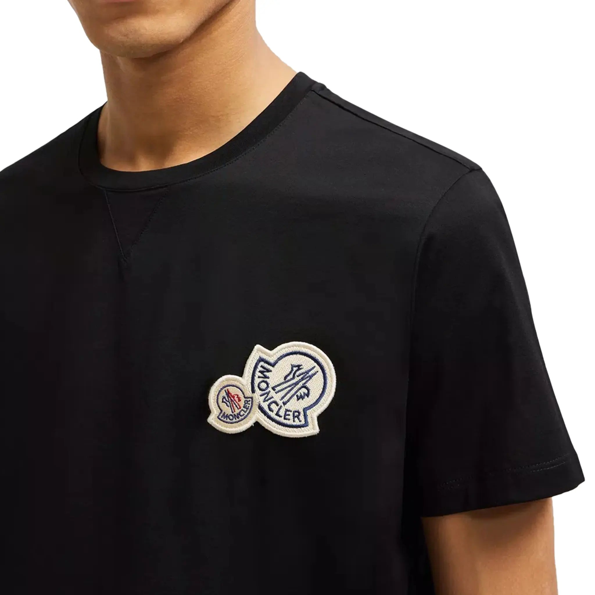 Model front view of Moncler Double Bell Logo Black T Shirt J10918C000588390Y999