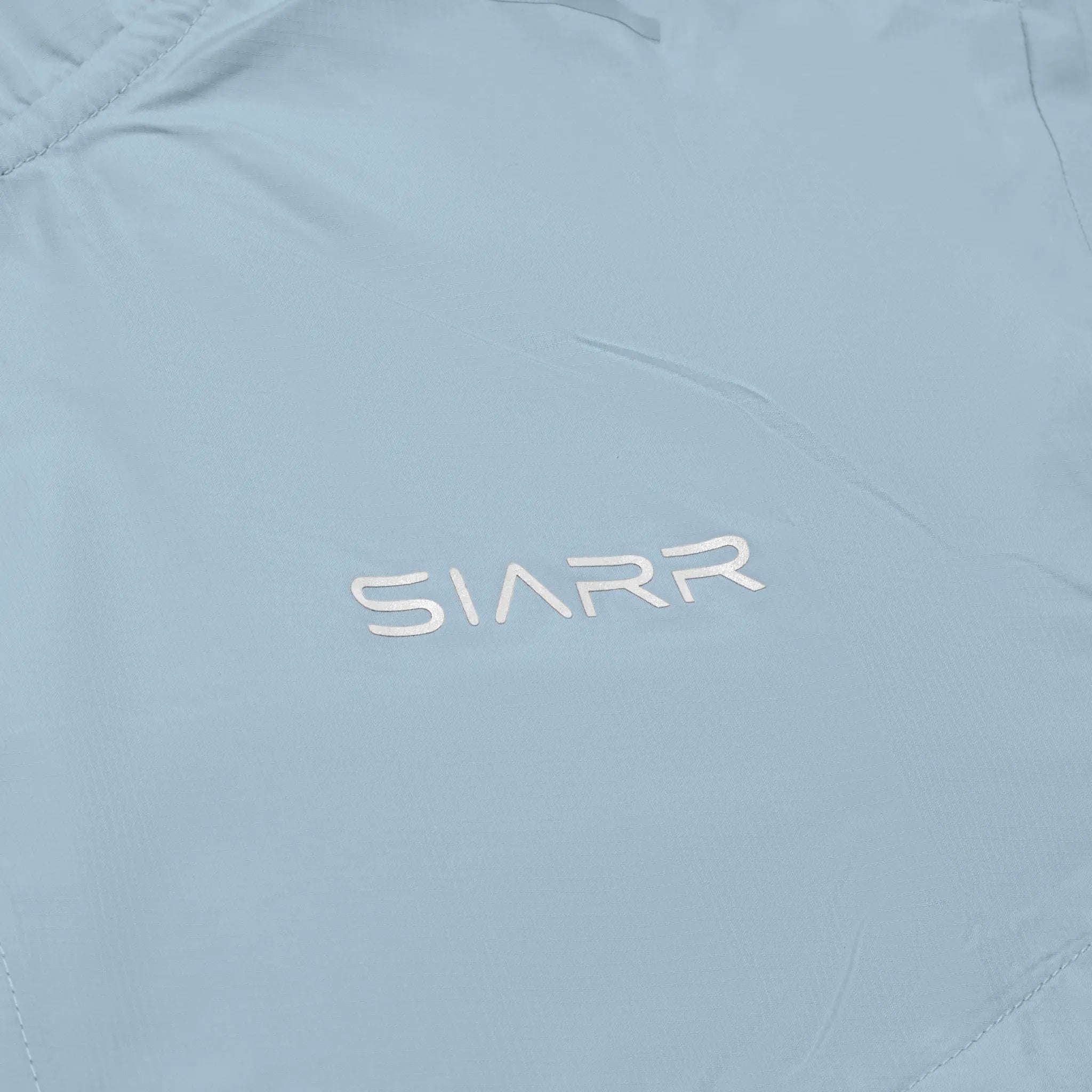 Chest logo view of Siarr Performance Baby Blue Windrunner