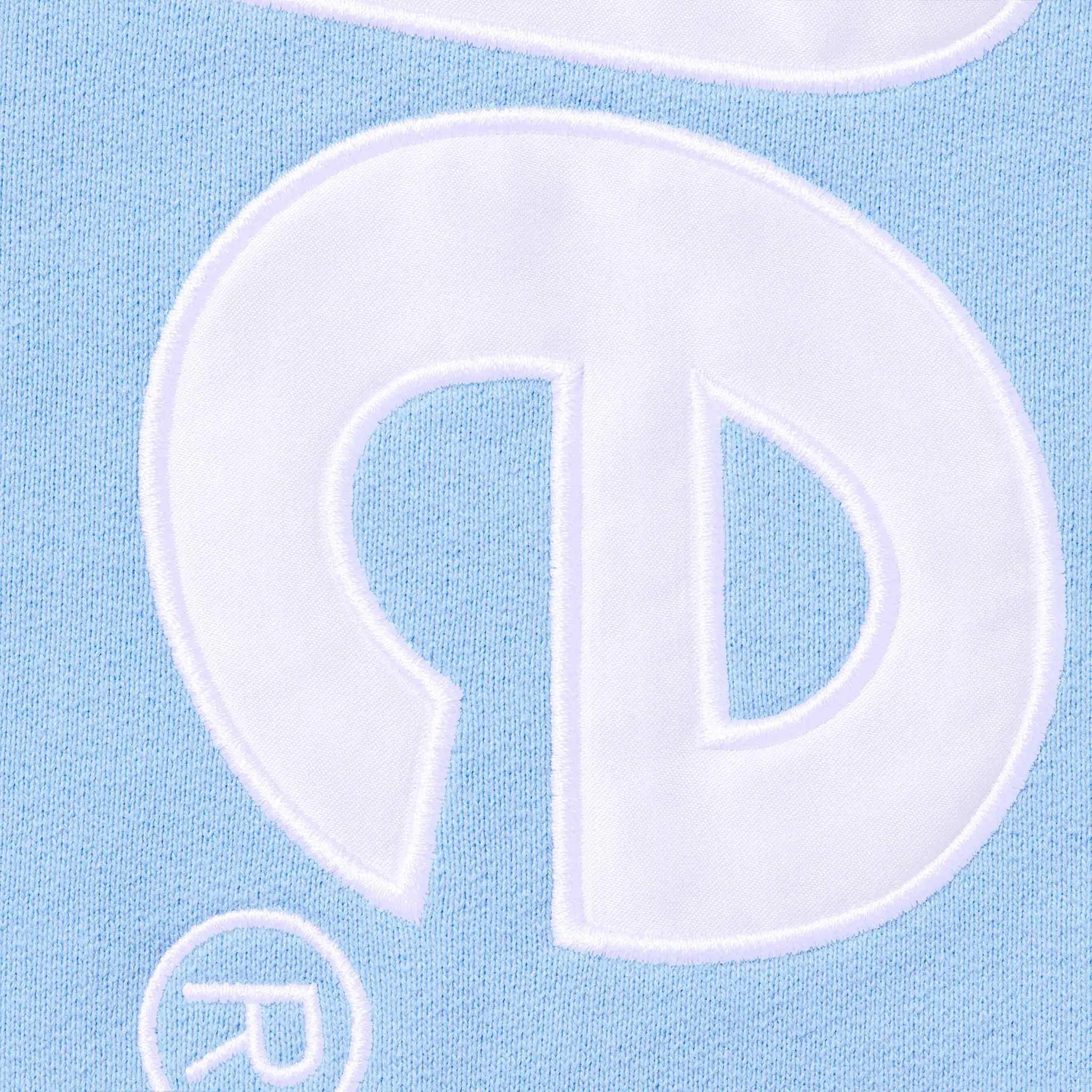 Detail view of Supreme Satin Applique Light Blue Hoodie FW24SW37 LIGHT BLUE