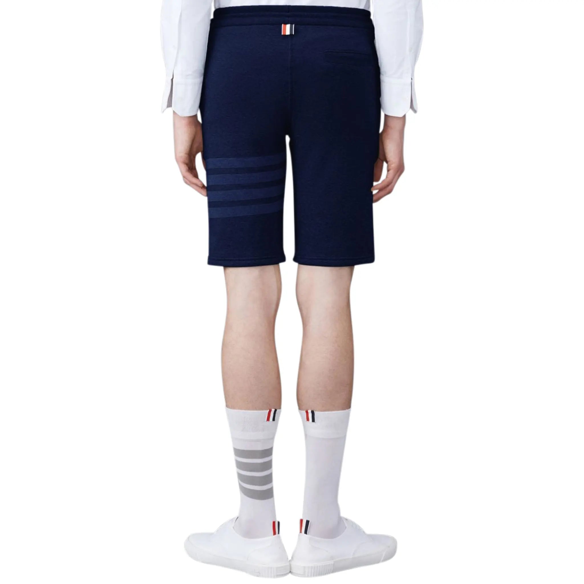 Model back view of Thom Browne Classic Loopback 4-Bar Blue Sweat Shorts MJQ012A-06910-415