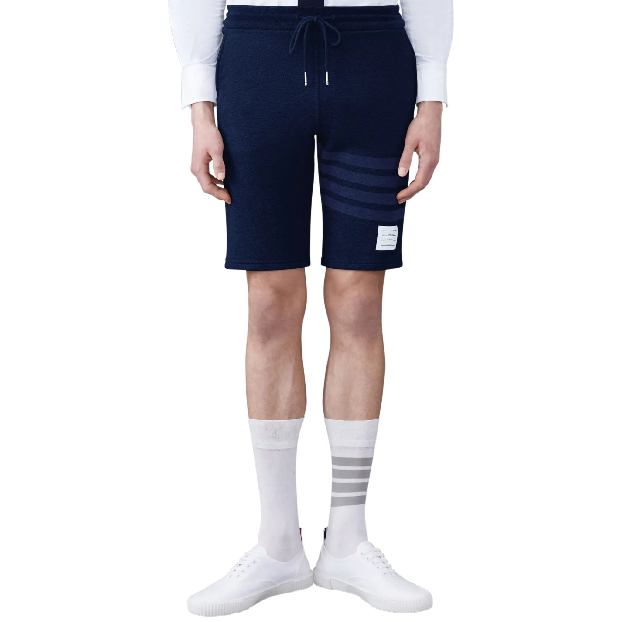 Model front view of Thom Browne Classic Loopback 4-Bar Blue Sweat Shorts MJQ012A-06910-415