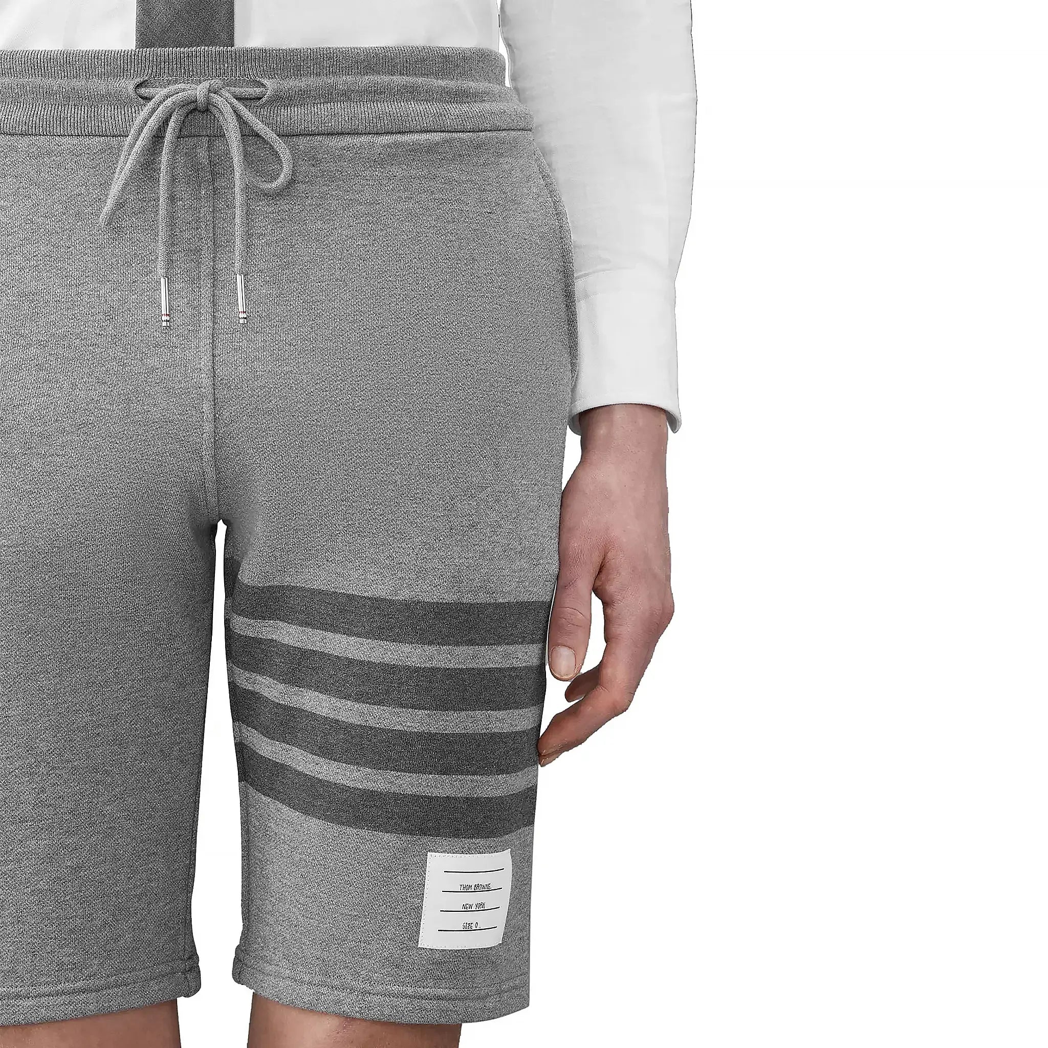 Model detail view of Thom Browne Classic Loopback 4-Bar Grey Sweat Shorts MJQ012H-00535-068