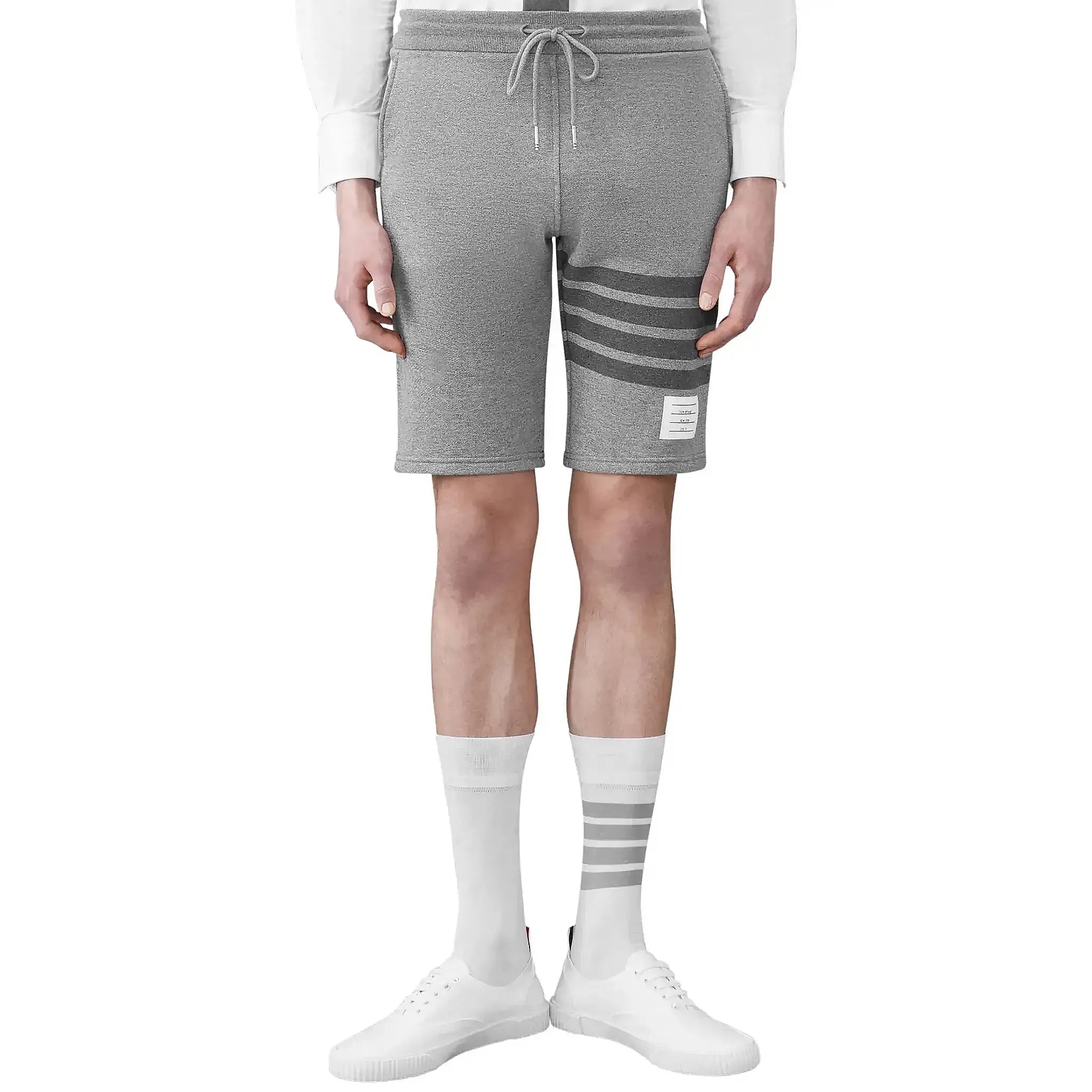 Model front view of Thom Browne Classic Loopback 4-Bar Grey Sweat Shorts MJQ012H-00535-068